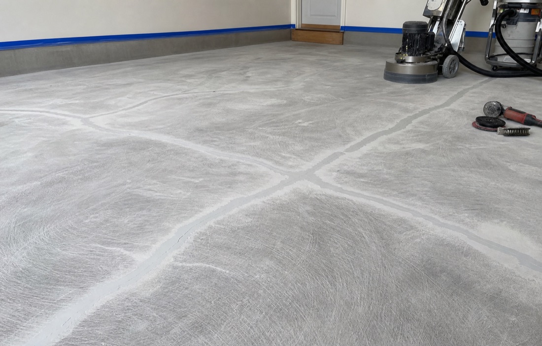 Concrete being diamond-ground and prepped before coating